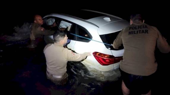 Policiais conseguiram retirar o suspeito pela janela do carro, que estava sendo levado pela maré
