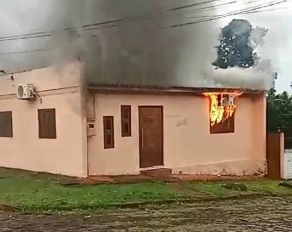 A imagem mostra as labaredas e a fumaça saindo do interior da casa