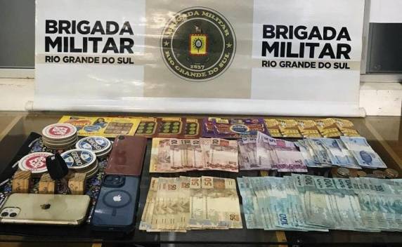 A ação ocorreu após a abordagem de um veículo Astra, onde foram encontrados bilhetes de raspadinha, dinheiro em espécie e aparelhos celulares durante a revista.