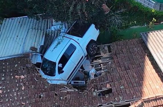 Condutor foi resgatado consciente e encaminhado ao hospital; moradores não estavam na residência no momento do acidente